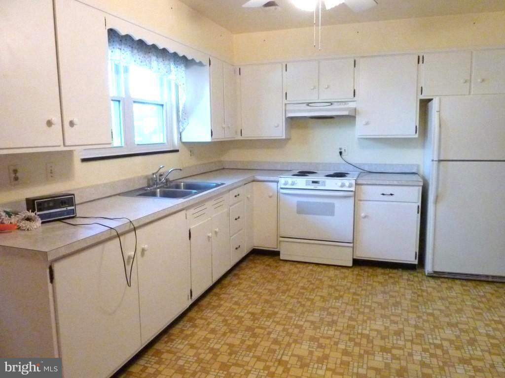 1505 Hamlin Street Northeast Washington, DC 20017 - Photo 8 of 30 a kitchen with stainless steel appliances granite countertop a sink stove and cabinets