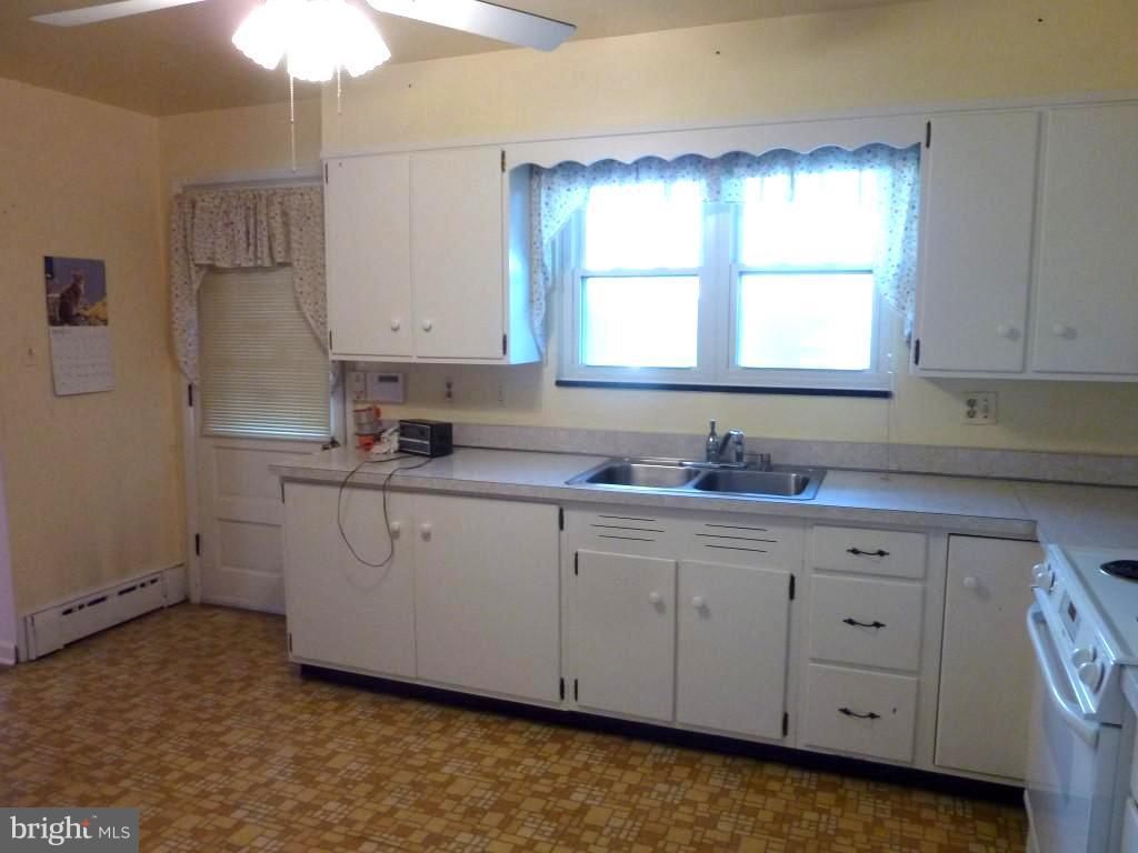 1505 Hamlin Street Northeast Washington, DC 20017 - Photo 9 of 30 a kitchen with cabinets appliances a sink and a window