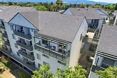 an aerial view of a house with a yard and a wooden fence