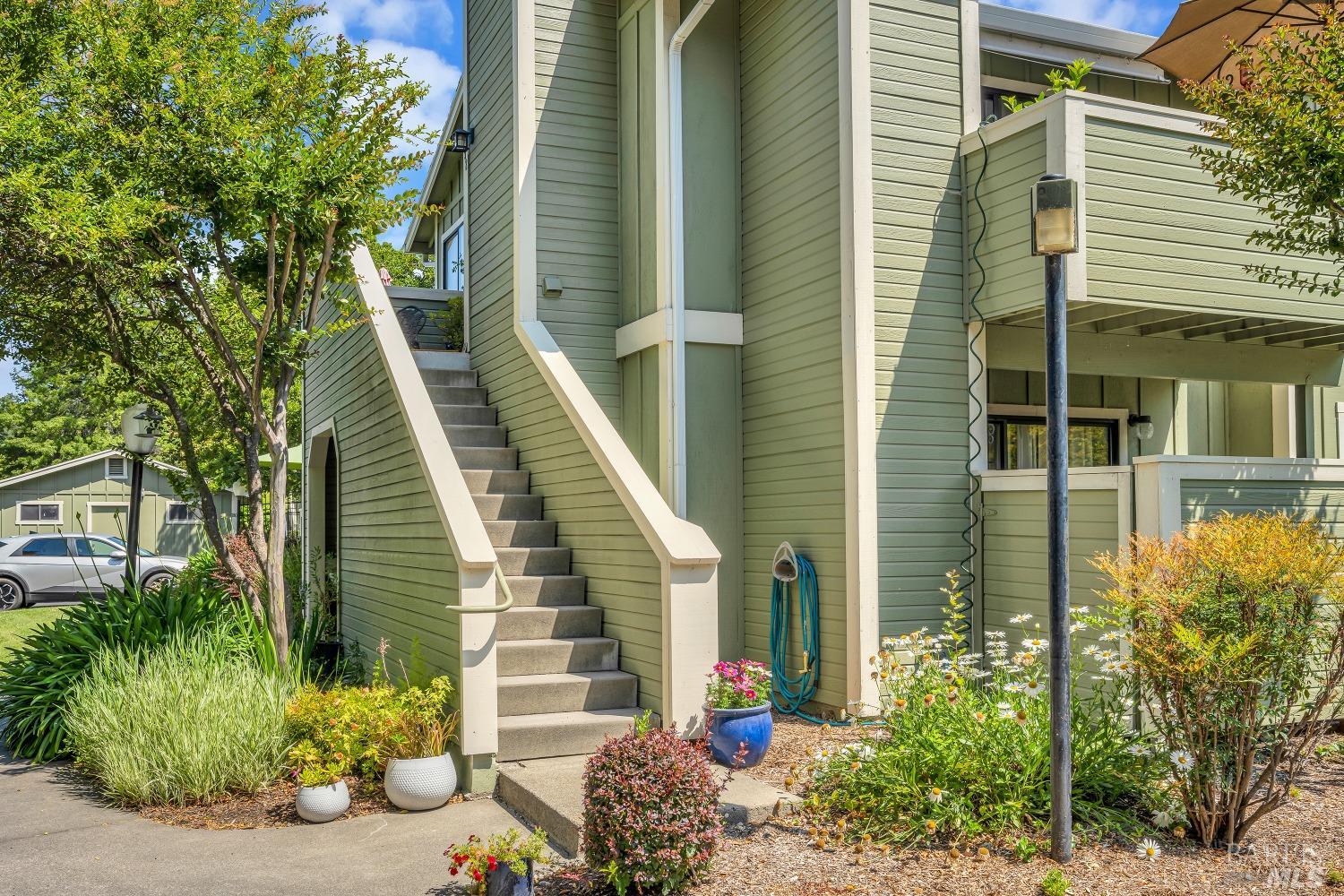 a view of a house with potted plants