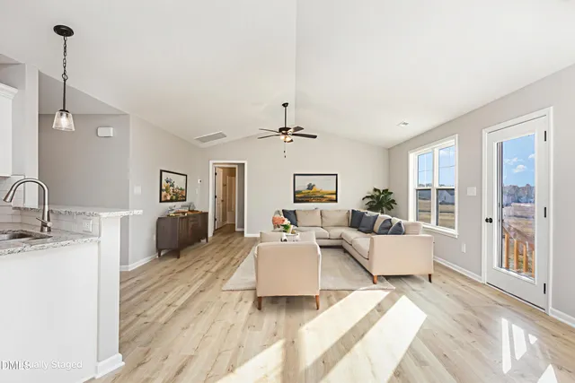 a living room with furniture and a chandelier