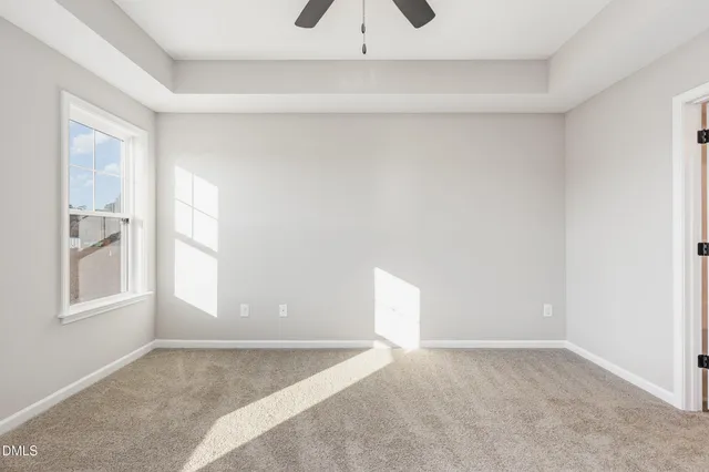 a bedroom with a bed potted plant and a window