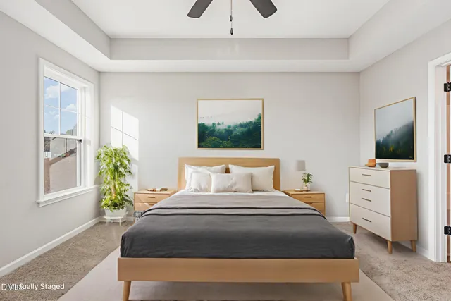 a spacious bathroom with a tub sink and mirror