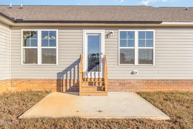 a view of a house with a road