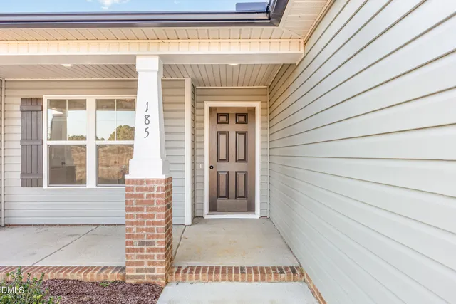 a view of a house with a door and wooden floor