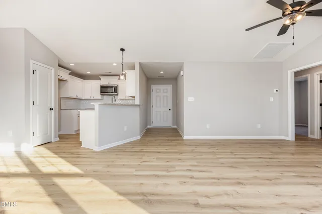 a view of a kitchen with a sink and cabinets