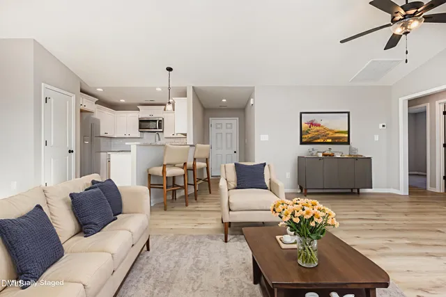 a living room with furniture and a wooden floor
