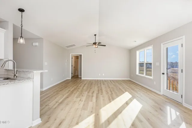 a view of a kitchen with a sink and cabinets