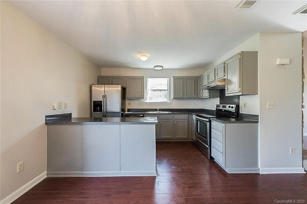 8207 Golf Ridge Drive Charlotte, NC 28277 - Photo 2 of 15 a kitchen with a sink cabinets and wooden floor