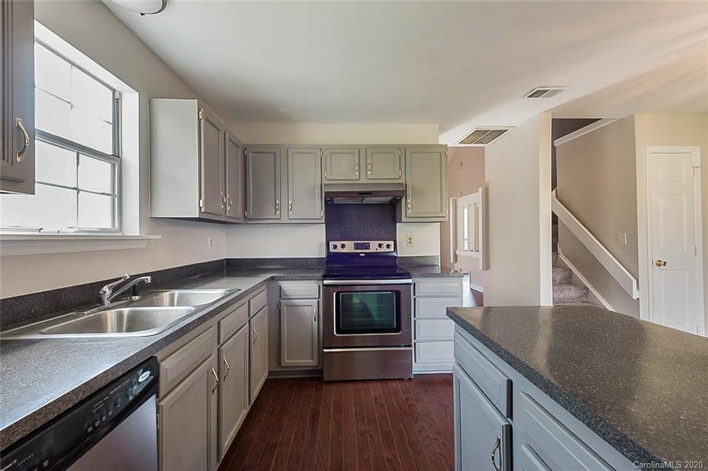 8207 Golf Ridge Drive Charlotte, NC 28277 - Photo 6 of 15 a kitchen with stainless steel appliances granite countertop a sink a stove and a refrigerator