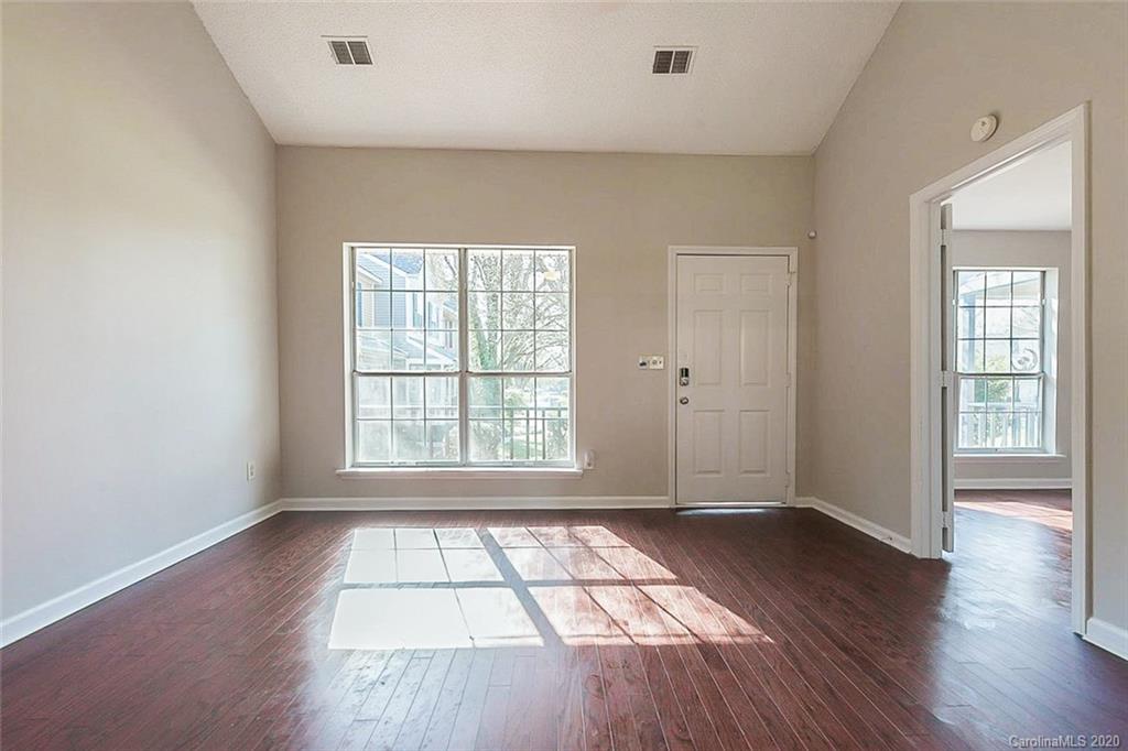 8207 Golf Ridge Drive Charlotte, NC 28277 - Photo 8 of 15 an empty room with wooden floor and windows