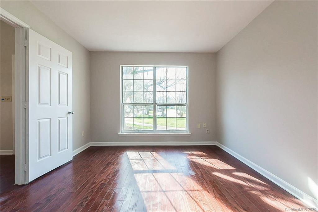 8207 Golf Ridge Drive Charlotte, NC 28277 - Photo 9 of 15 a view of empty room with wooden floor and fan