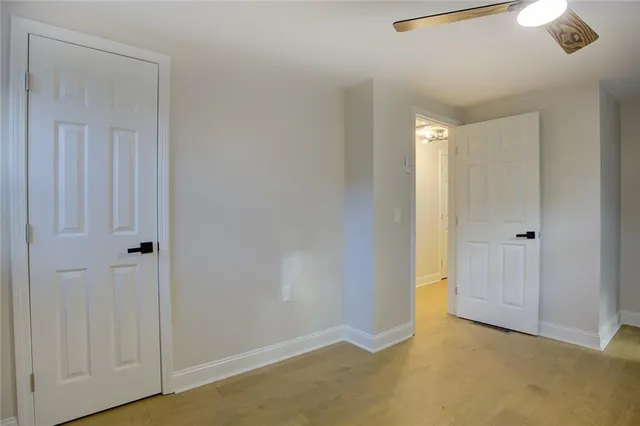 a bedroom with a large bed and a flat tv screen on dresser