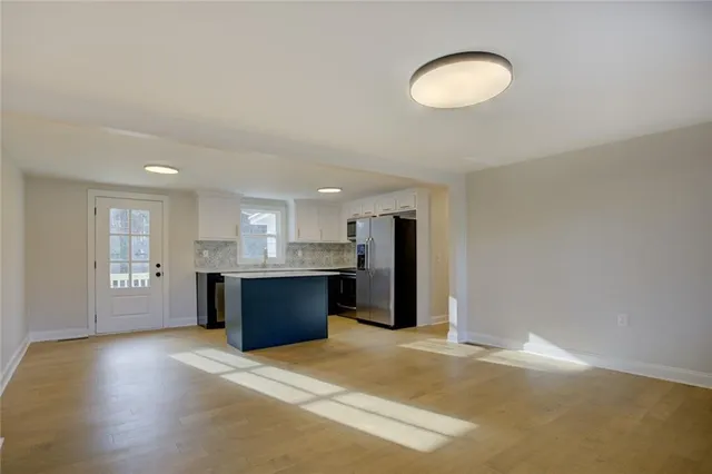 a backyard of a house with trees and barbeque oven