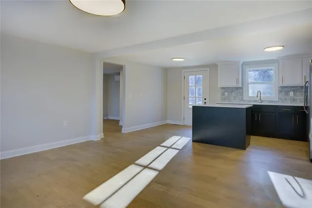 a view of a house with backyard and trees