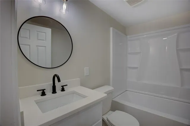 an empty room with a window and ceiling fan