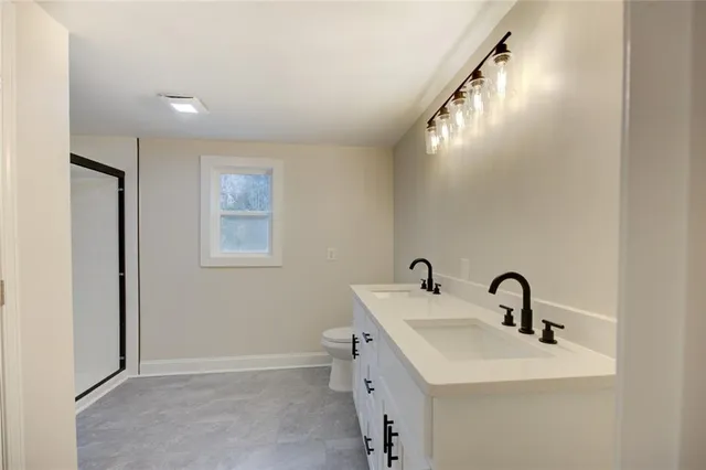 a bathroom with a glass shower door and mirror