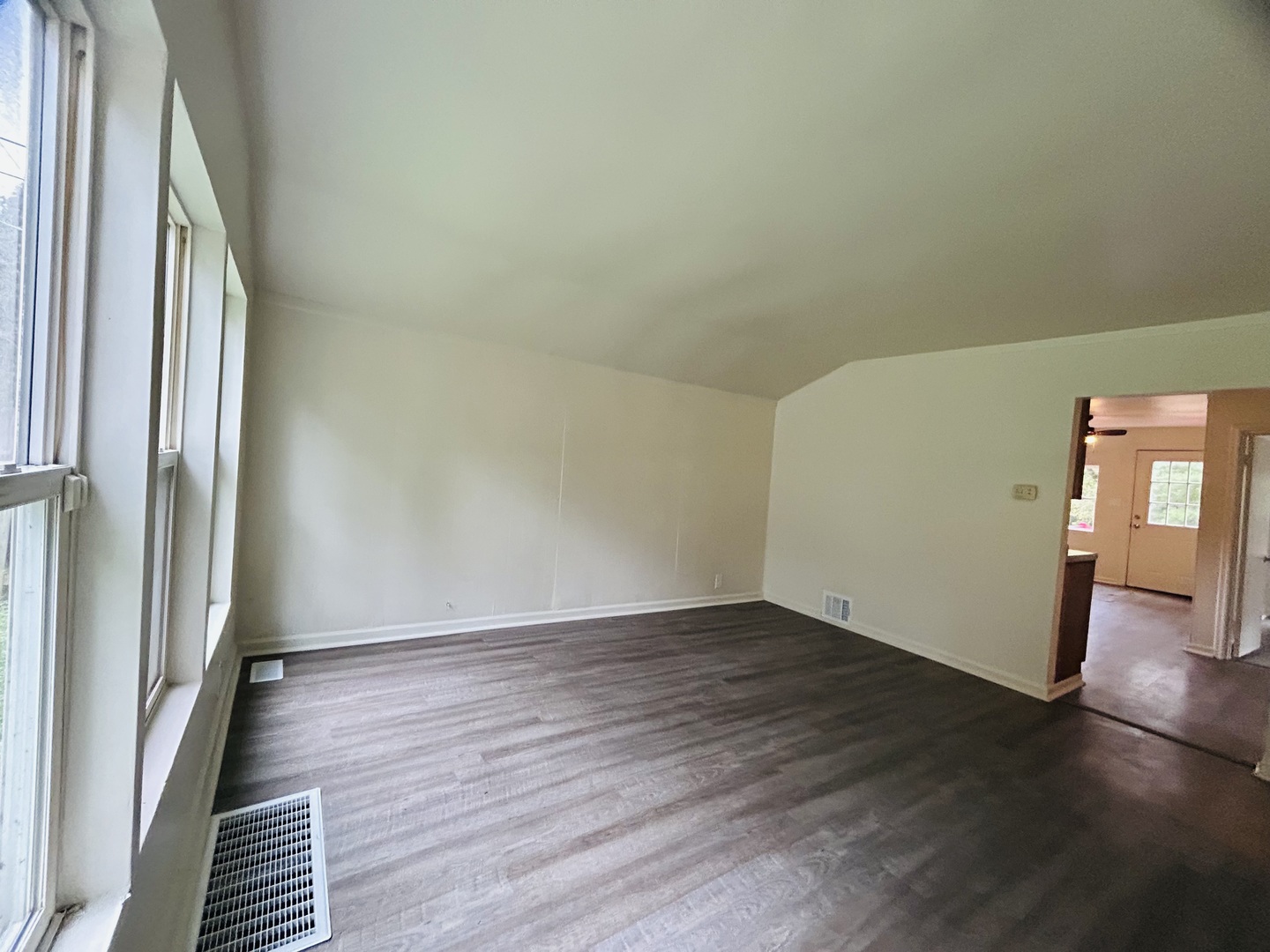 6415 North Shore Avenue Spring Grove, IL 60081 - Photo 3 of 15 a view of an empty room with wooden floor and a window