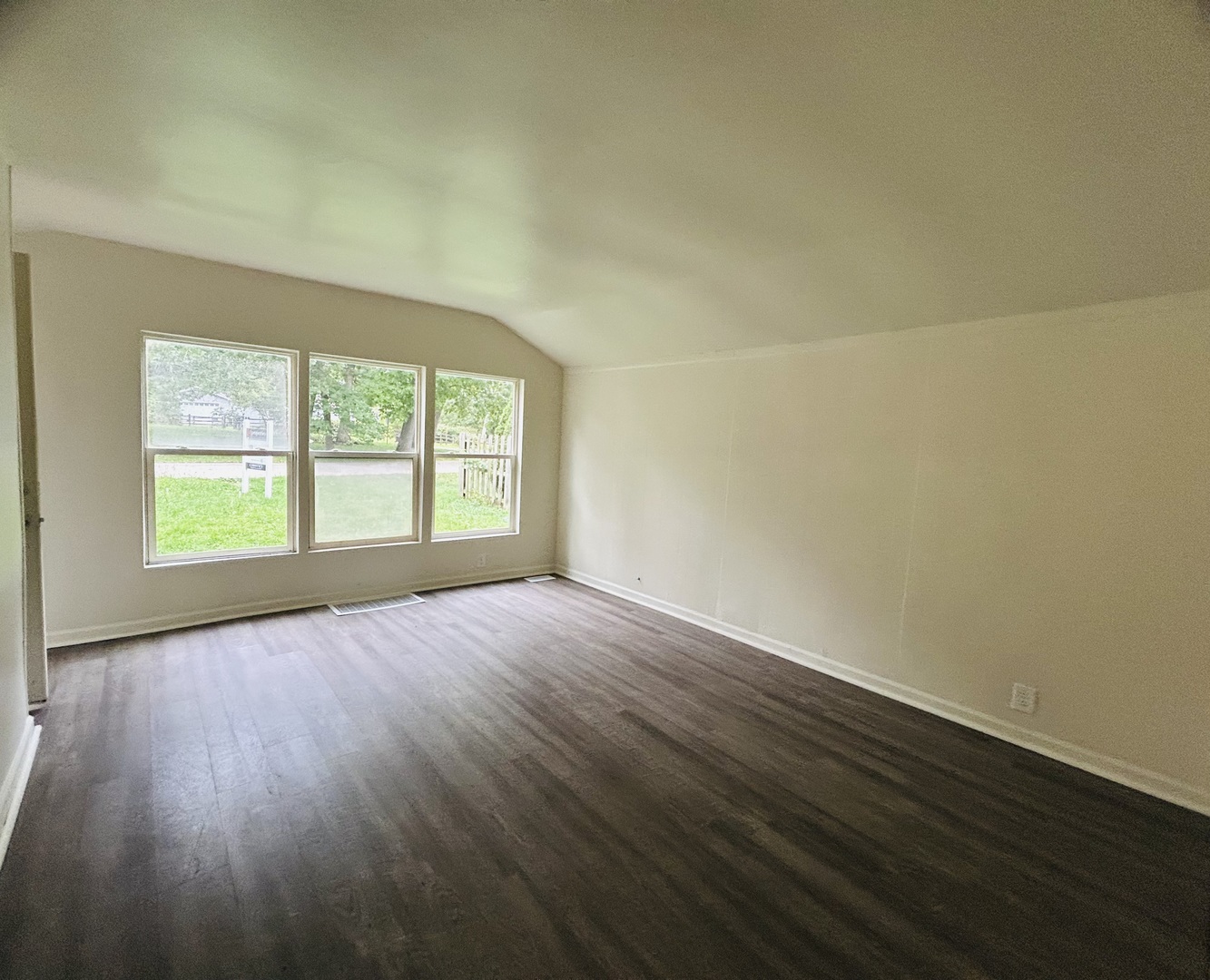 6415 North Shore Avenue Spring Grove, IL 60081 - Photo 4 of 18 an empty room with wooden floor and windows