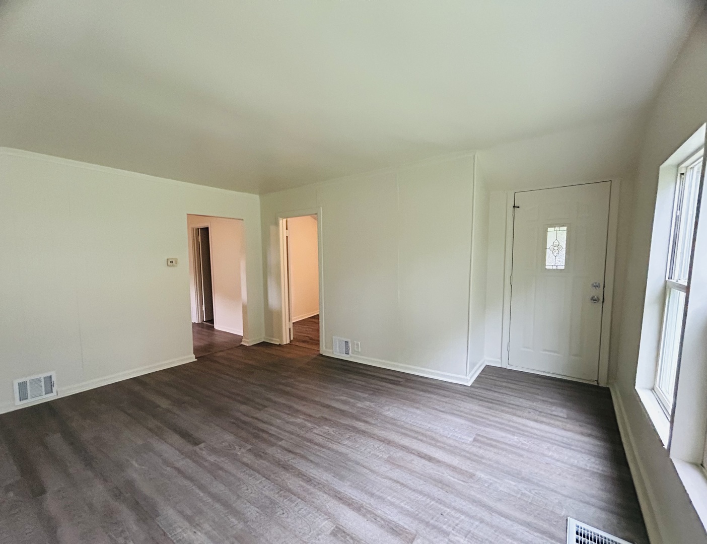 6415 North Shore Avenue Spring Grove, IL 60081 - Photo 4 of 15 an empty room with wooden floor and windows