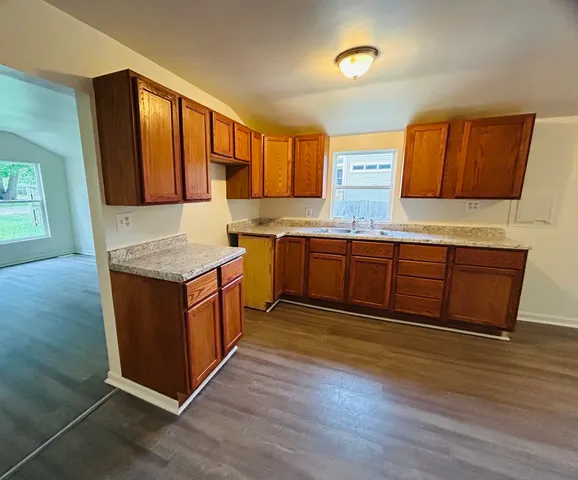 a kitchen with stainless steel appliances granite countertop a sink and a stove