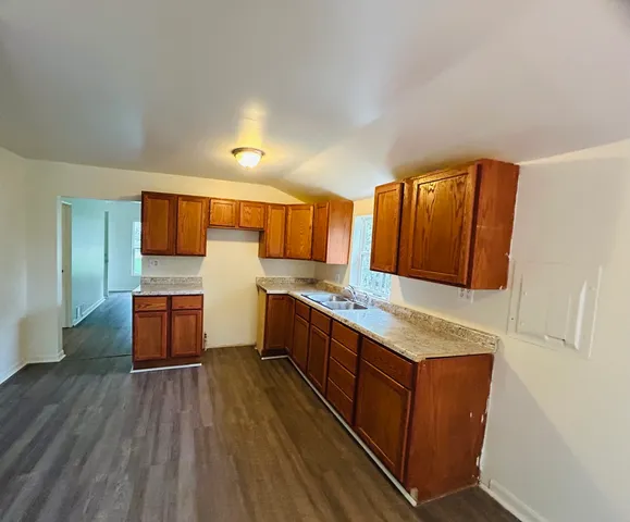 a kitchen with stainless steel appliances granite countertop a lot of counter space and wooden floor