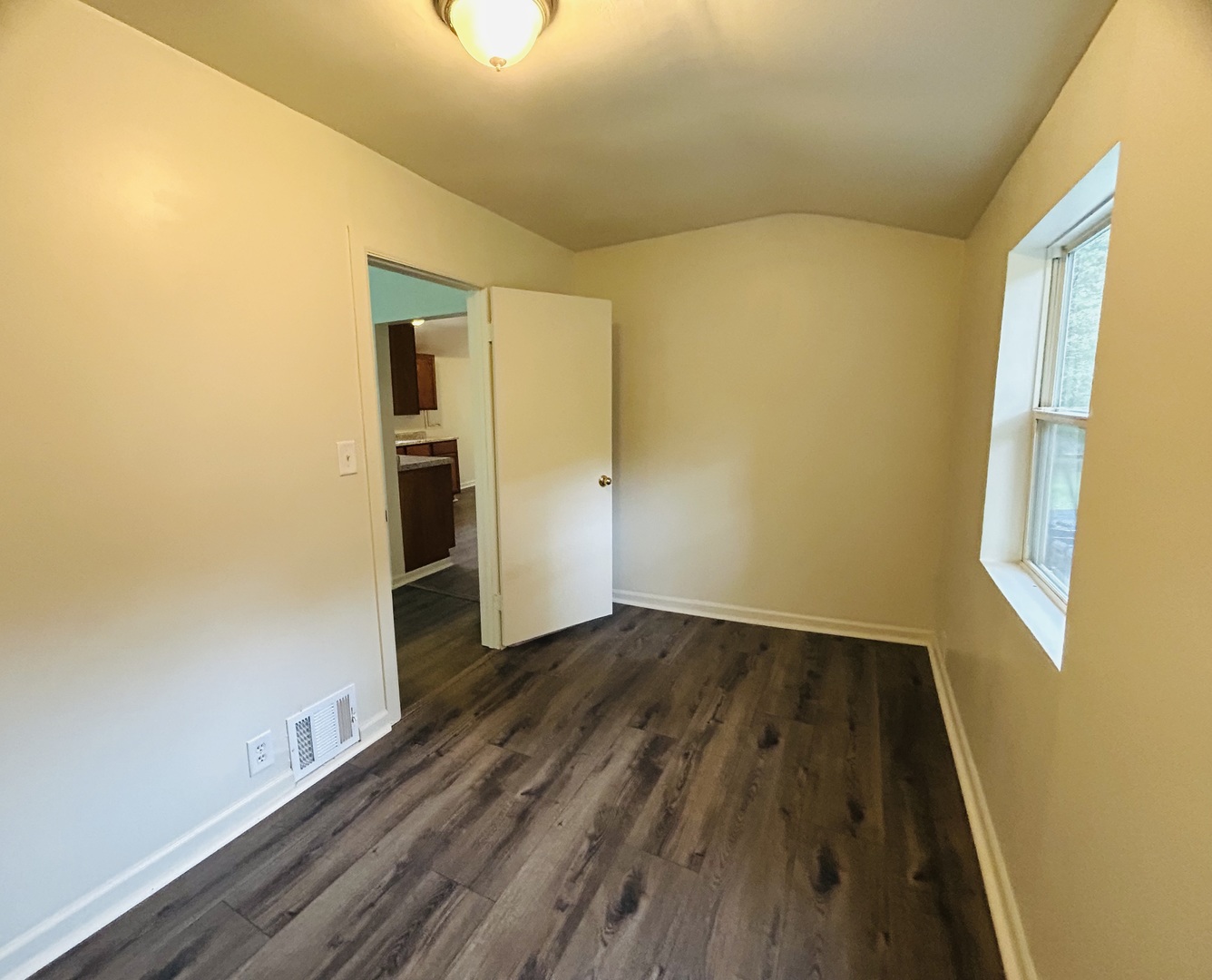 6415 North Shore Avenue Spring Grove, IL 60081 - Photo 10 of 18 a view of an empty room with wooden floor and a window