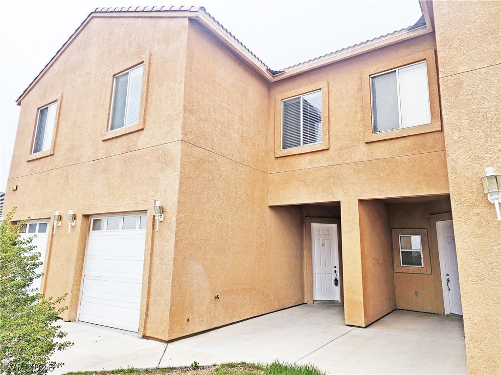 1421 Star Road, Unit 2 Pahrump, NV 89048 - Photo 2 of 33 Back of house with a garage and stucco siding