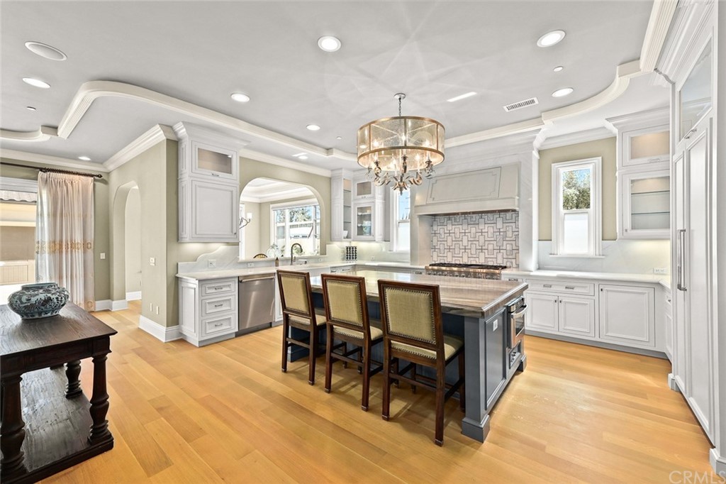 230 San Miguel Drive Arcadia, CA 91007 - Photo 13 of 57 a kitchen with stainless steel appliances kitchen island granite countertop a table chairs sink and cabinets