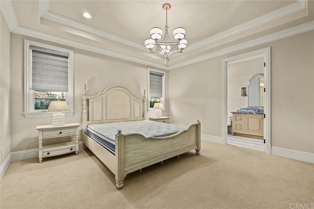 230 San Miguel Drive Arcadia, CA 91007 - Photo 30 of 57 a spacious bedroom with a bed and a chandelier
