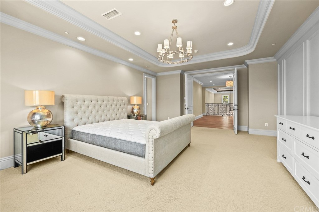 230 San Miguel Drive Arcadia, CA 91007 - Photo 38 of 57 a spacious bedroom with a bed and a chandelier