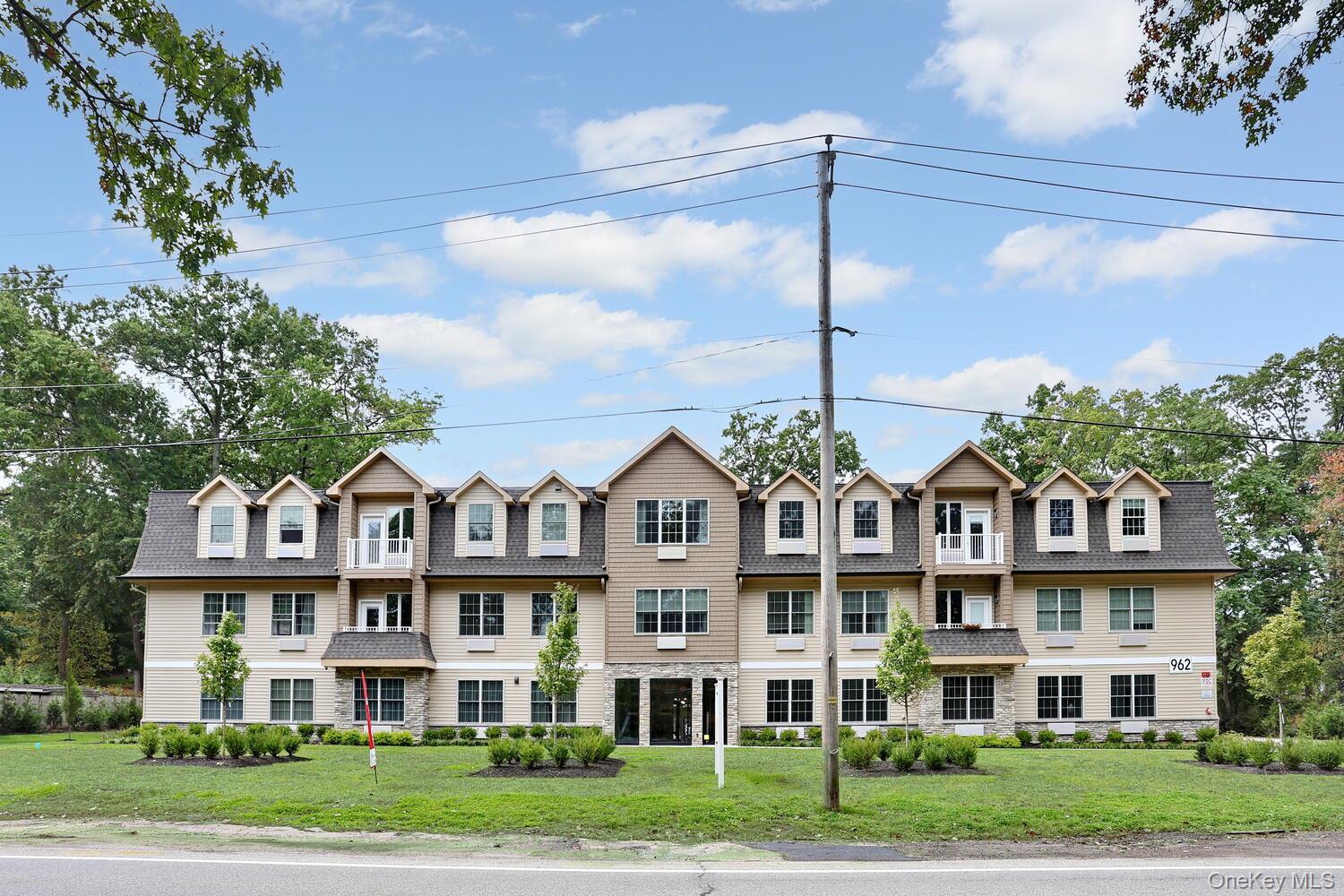 962 Rte 9W, Unit 104 Congers, NY 10920 - Photo 1 of 1 a front view of residential houses with yard and green space