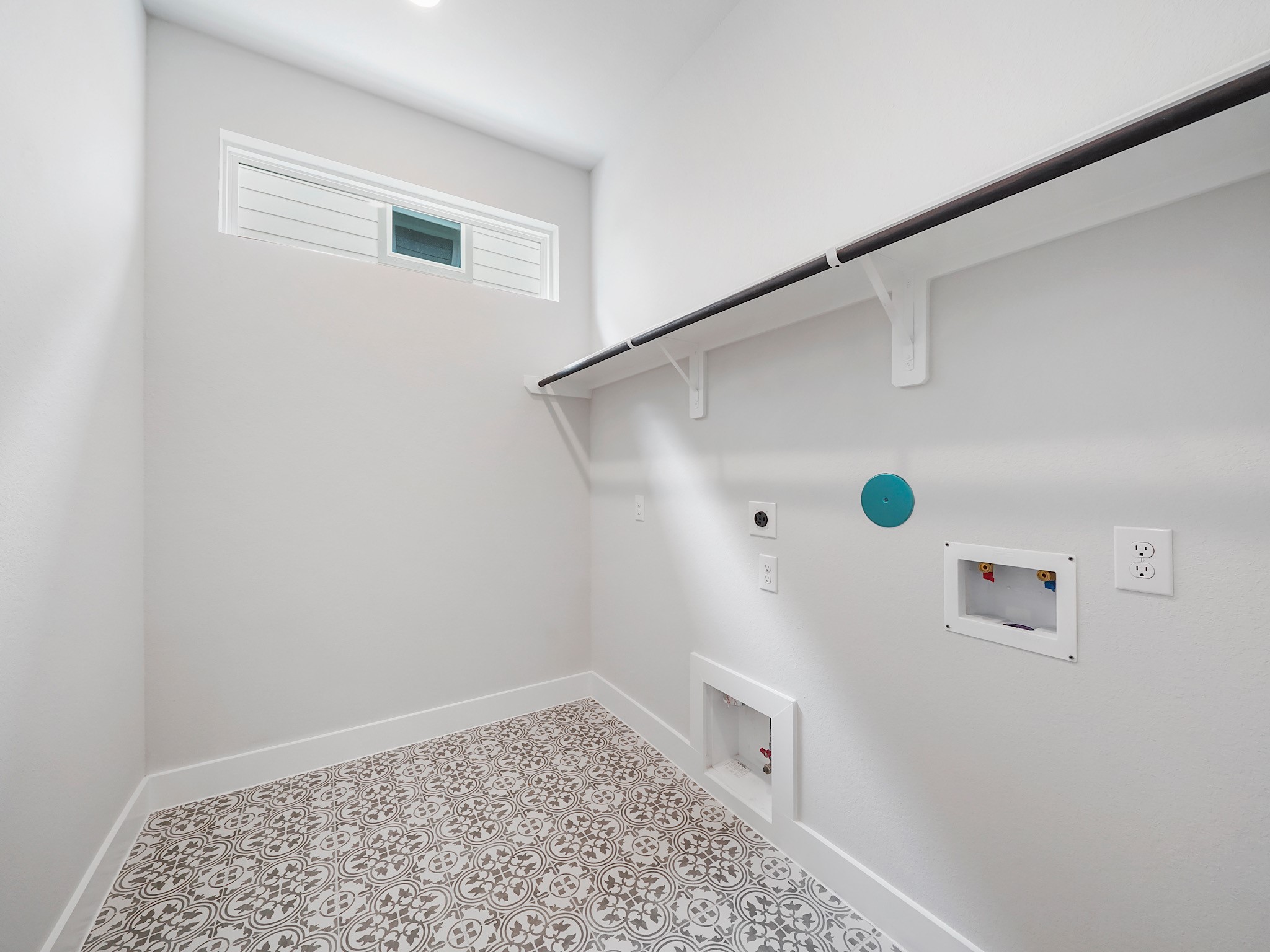 6010 Rolling Strm Court Fulshear, TX 77441 - Photo 12 of 23 Fall in love with the stunning utility room featuring decorative tile and convenient built-in shelf, perfect for maximizing storage and keeping your home organized.