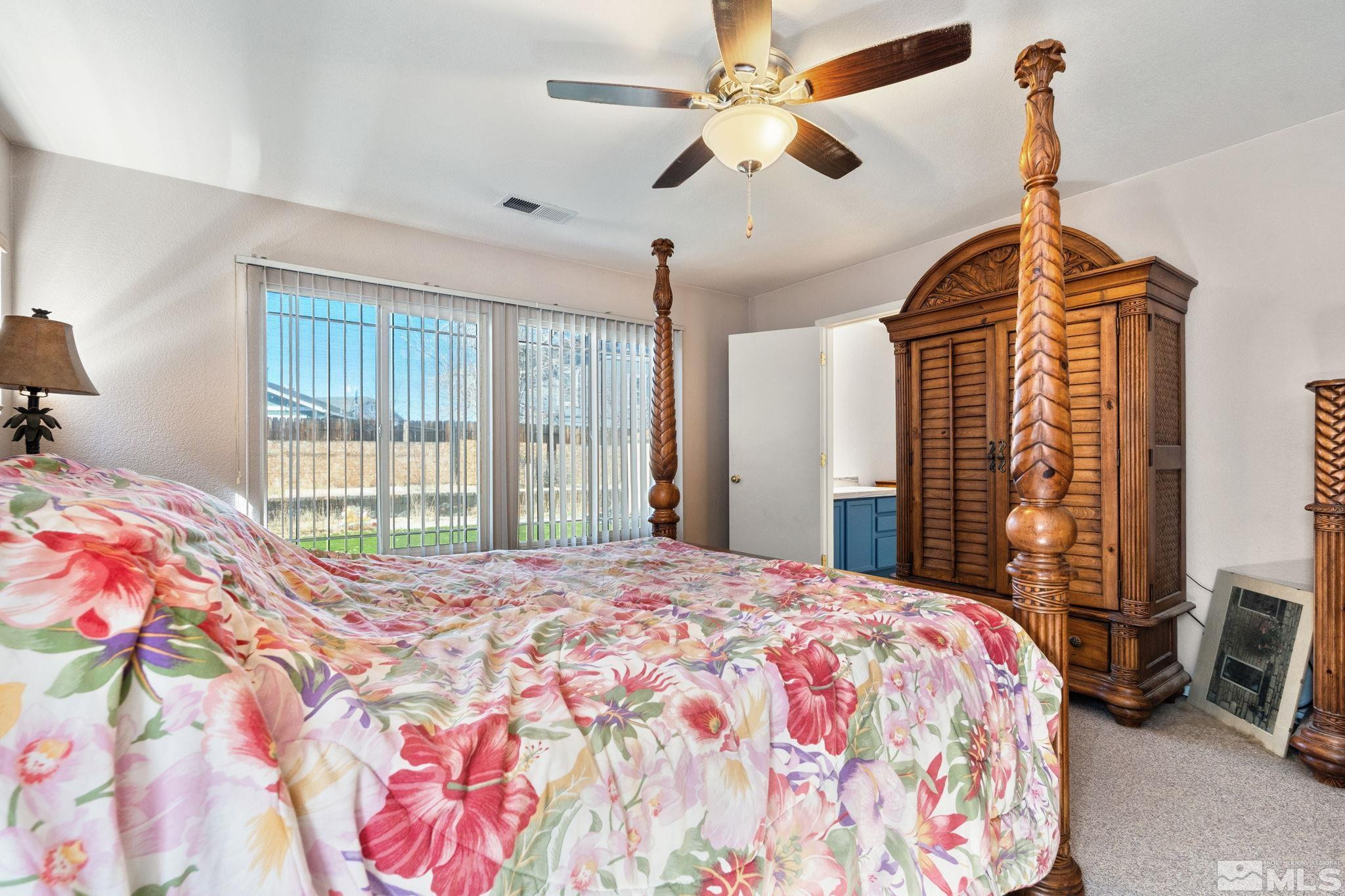 7721 Welsh Drive Reno, NV 89506 - Photo 16 of 27 a bedroom with a bed dresser and a window