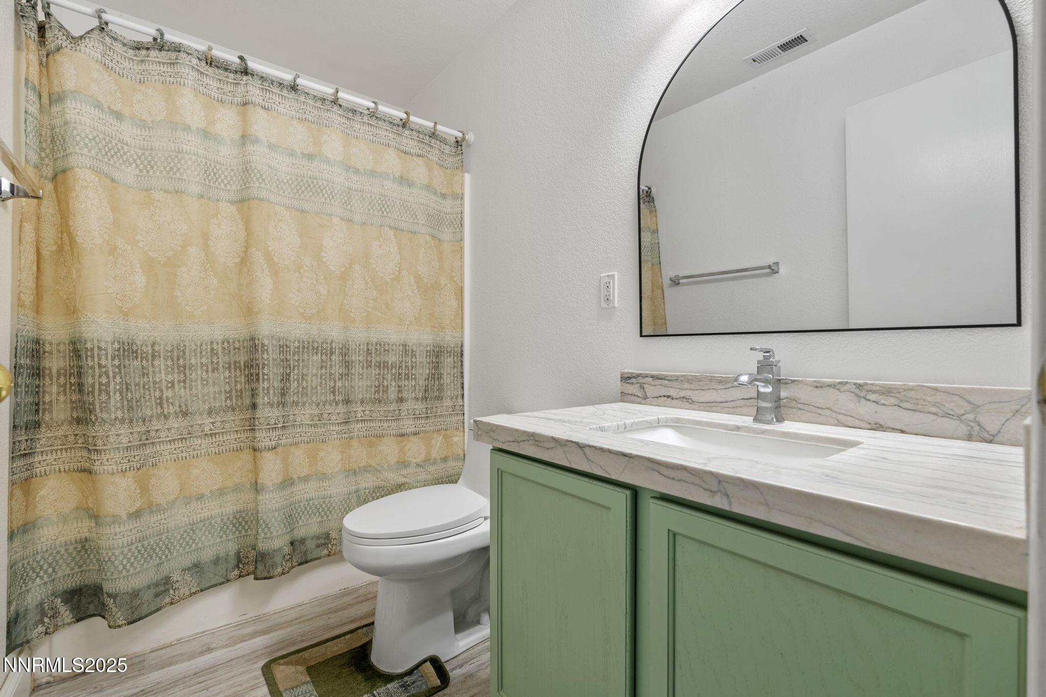 7721 Welsh Drive Reno, NV 89506 - Photo 19 of 27 a bathroom with a granite countertop sink a toilet and shower