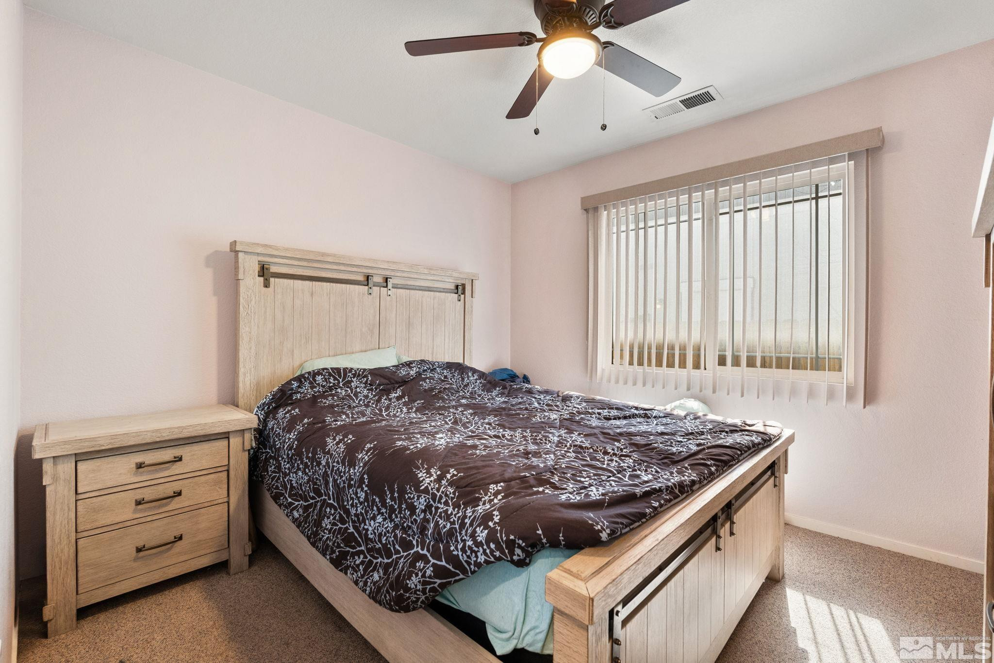 7721 Welsh Drive Reno, NV 89506 - Photo 20 of 27 a bed sitting in a bedroom next to a window