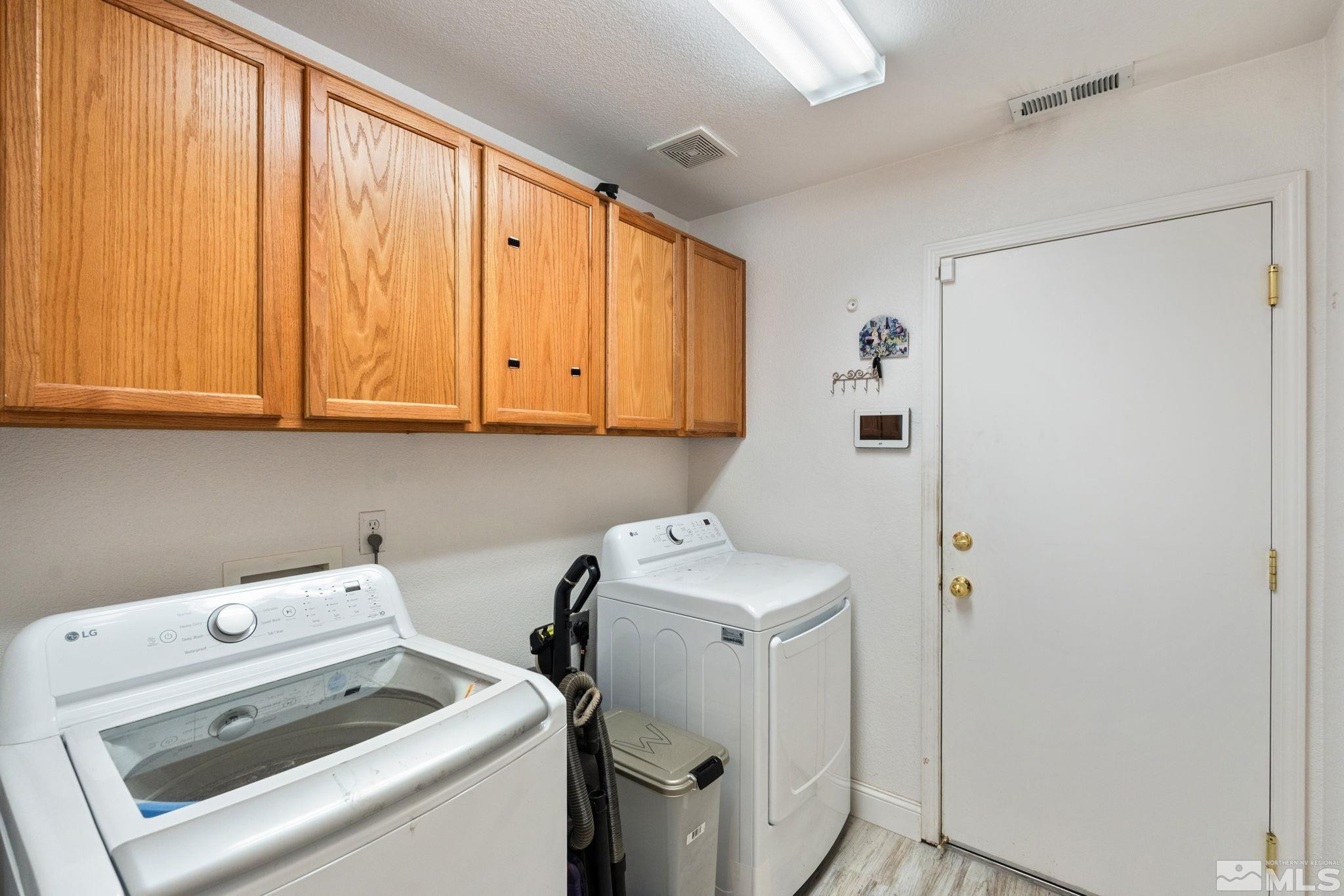 7721 Welsh Drive Reno, NV 89506 - Photo 22 of 27 a view of storage and utility room with washer and dryer