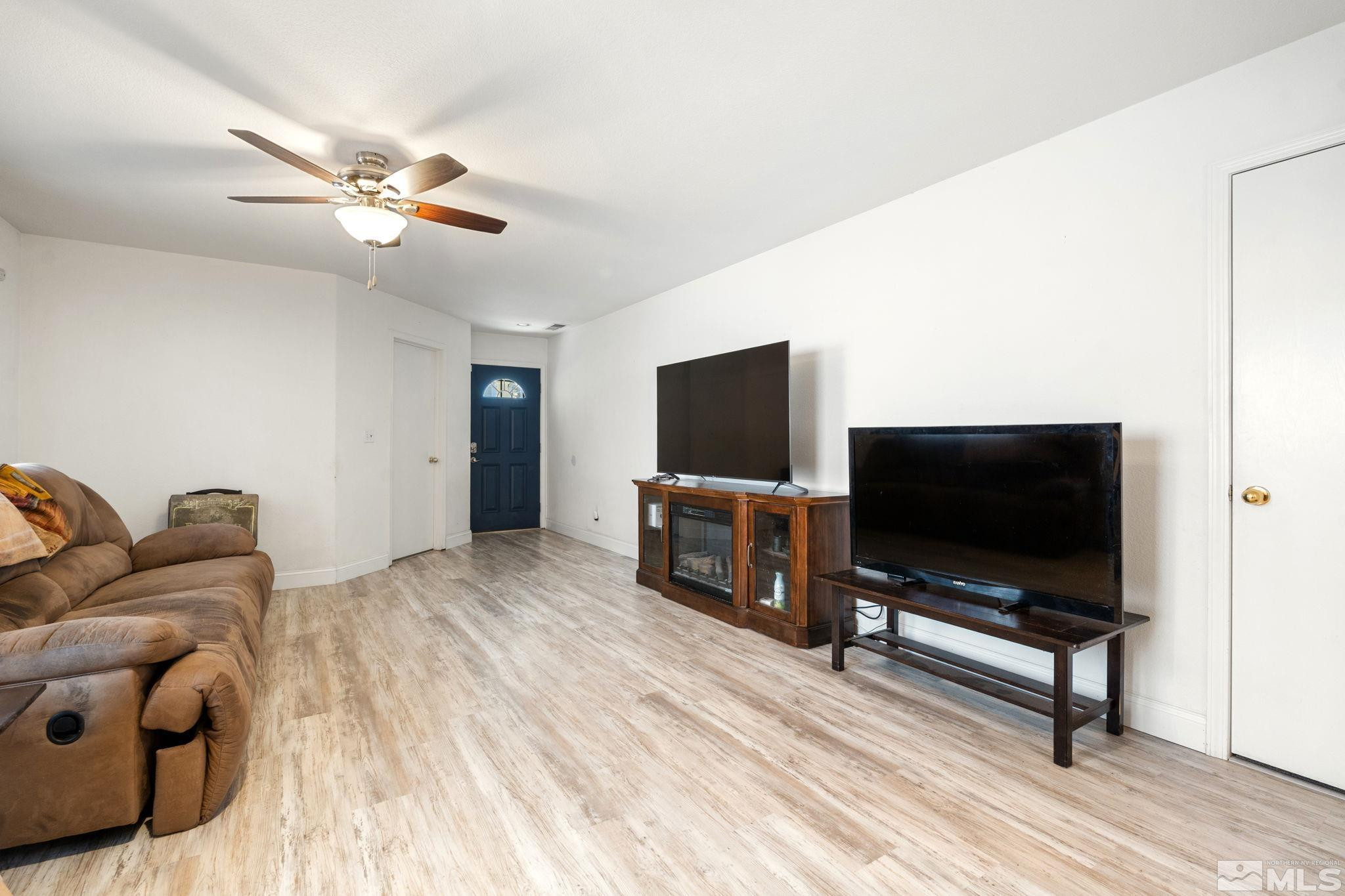 7721 Welsh Drive Reno, NV 89506 - Photo 2 of 27 a living room with furniture and a flat screen tv