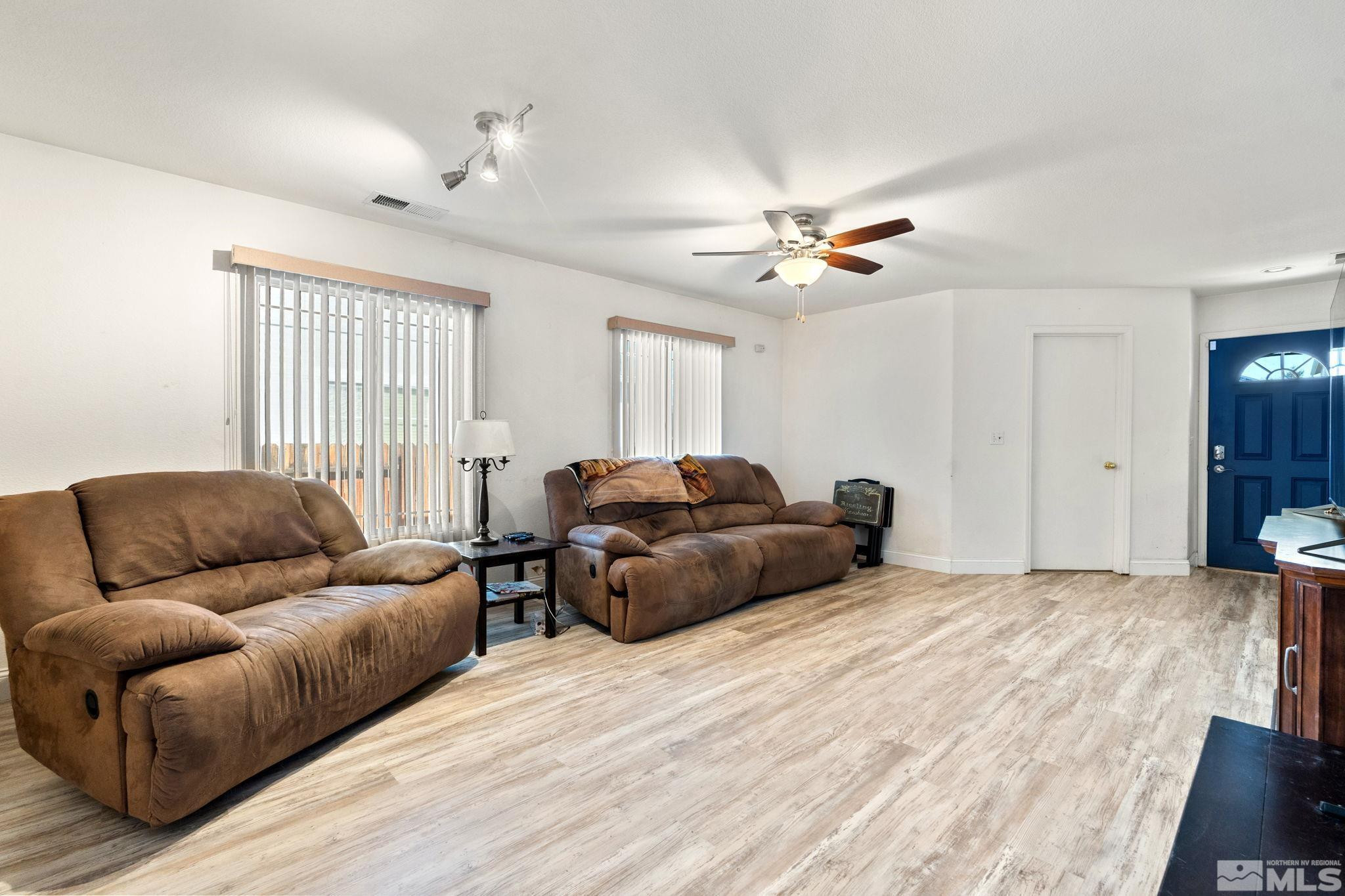 7721 Welsh Drive Reno, NV 89506 - Photo 3 of 27 a living room with furniture ceiling fan and a wooden floor