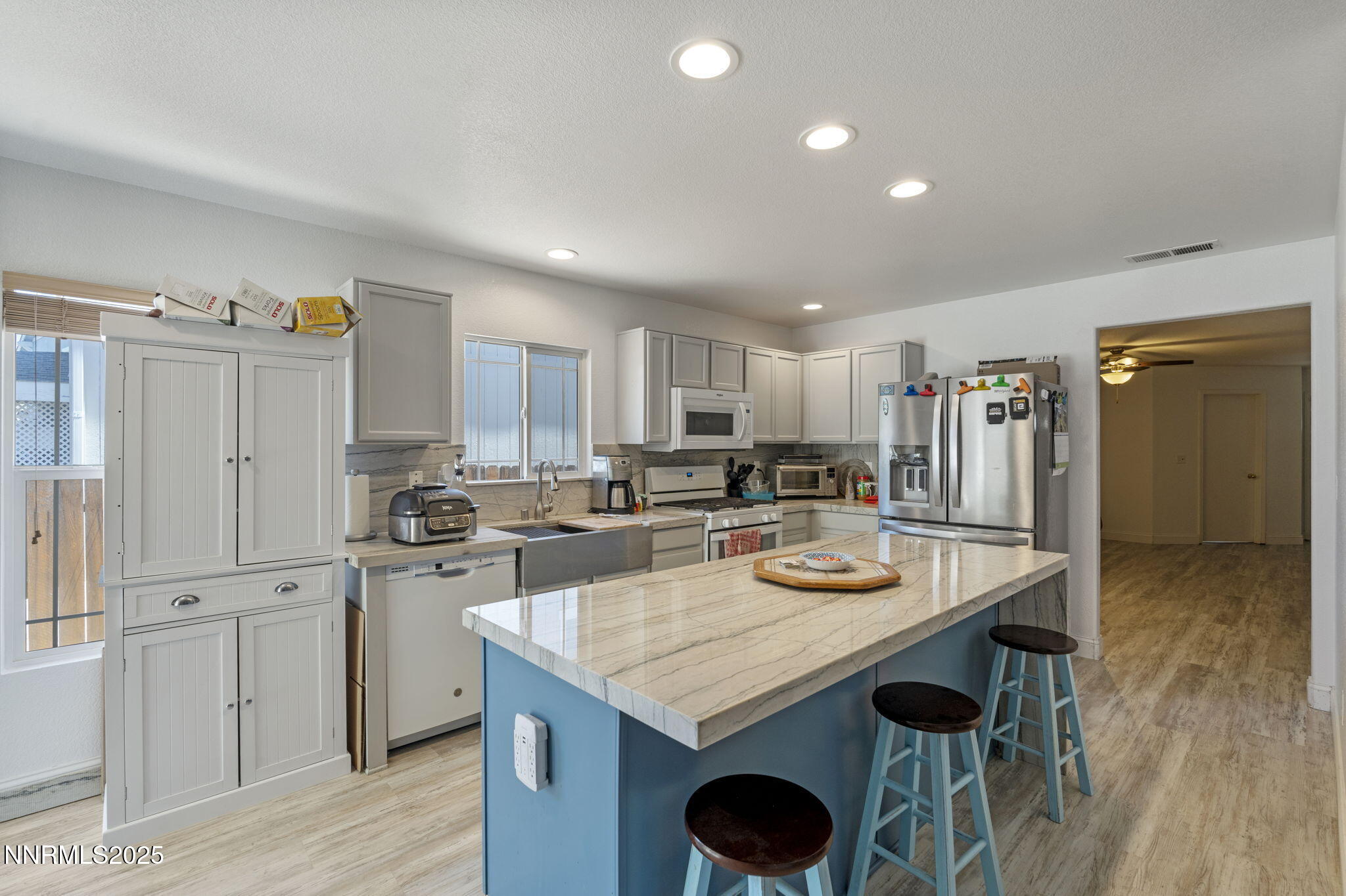 7721 Welsh Drive Reno, NV 89506 - Photo 6 of 27 a kitchen with stainless steel appliances granite countertop a stove and white cabinets