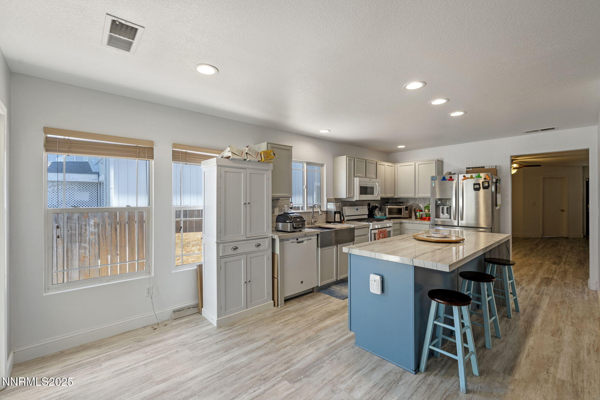 7721 Welsh Drive Reno, NV 89506 - Photo 8 of 27 a kitchen with refrigerator and wooden floor