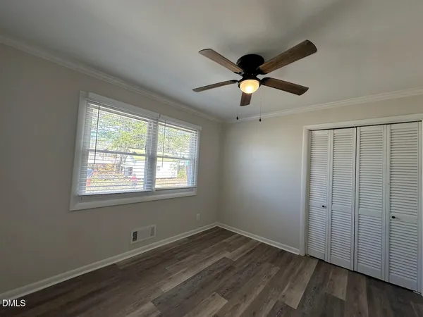 wooden floor in an empty room with a window