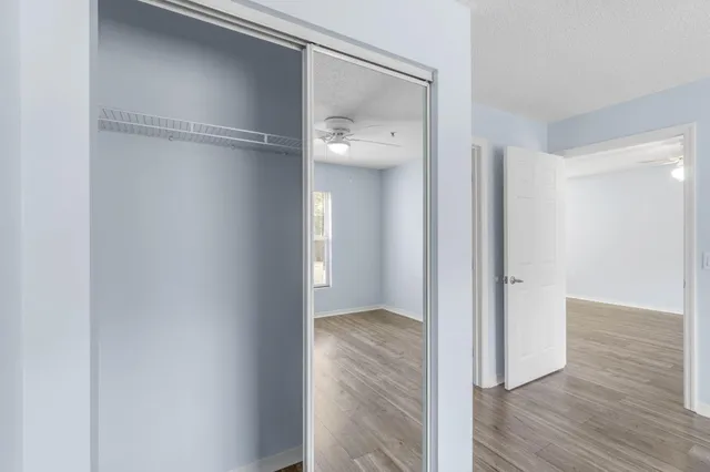 a view of a hallway with wooden floor