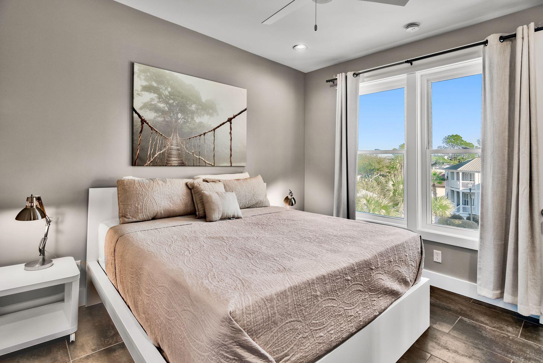 106 St Simon Circle Miramar Beach, FL 32550 - Photo 14 of 27 a large bed sitting in a bedroom next to a window