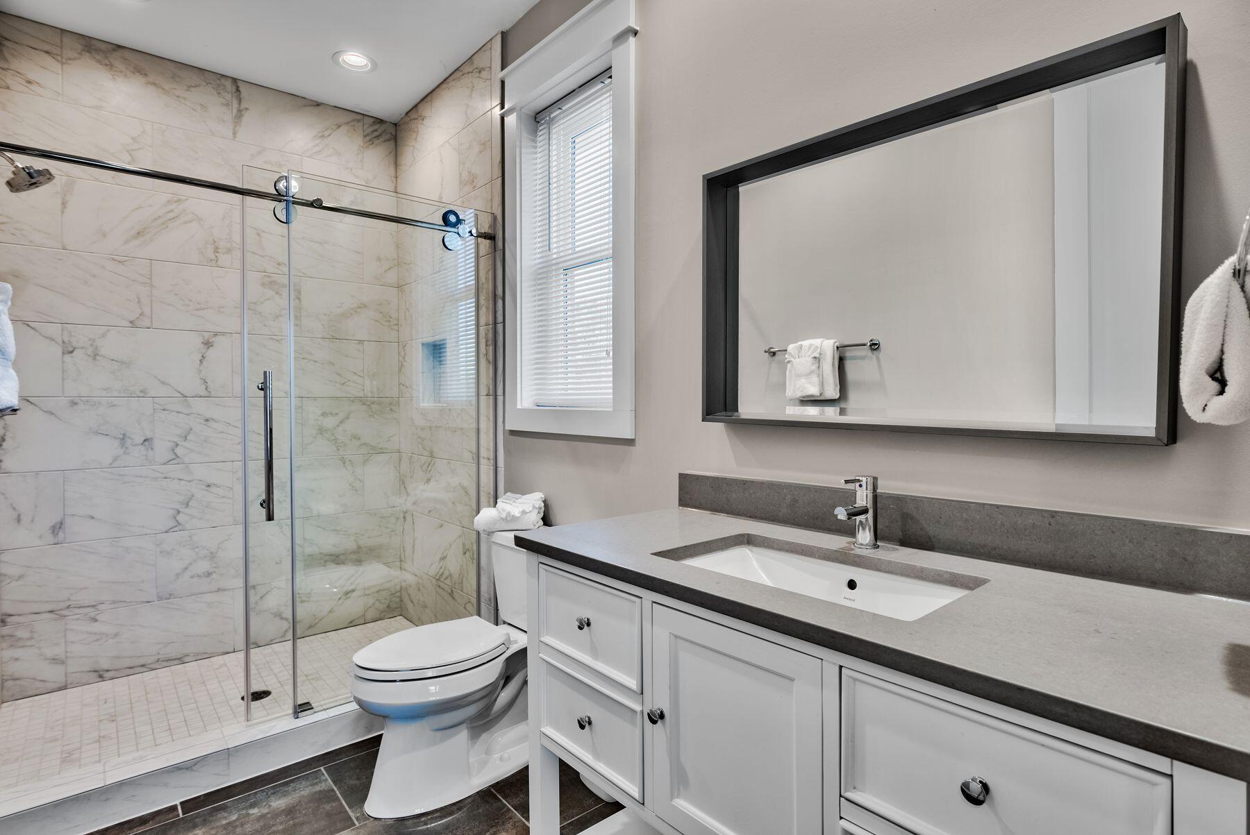 106 St Simon Circle Miramar Beach, FL 32550 - Photo 15 of 27 a bathroom with a toilet sink a mirror and shower