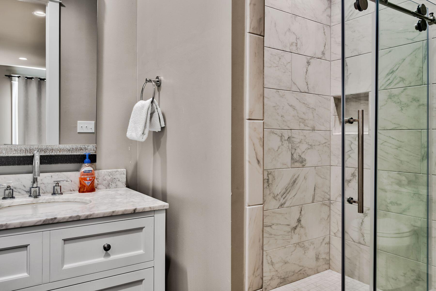 106 St Simon Circle Miramar Beach, FL 32550 - Photo 19 of 27 a bathroom with a granite countertop sink a mirror and shower