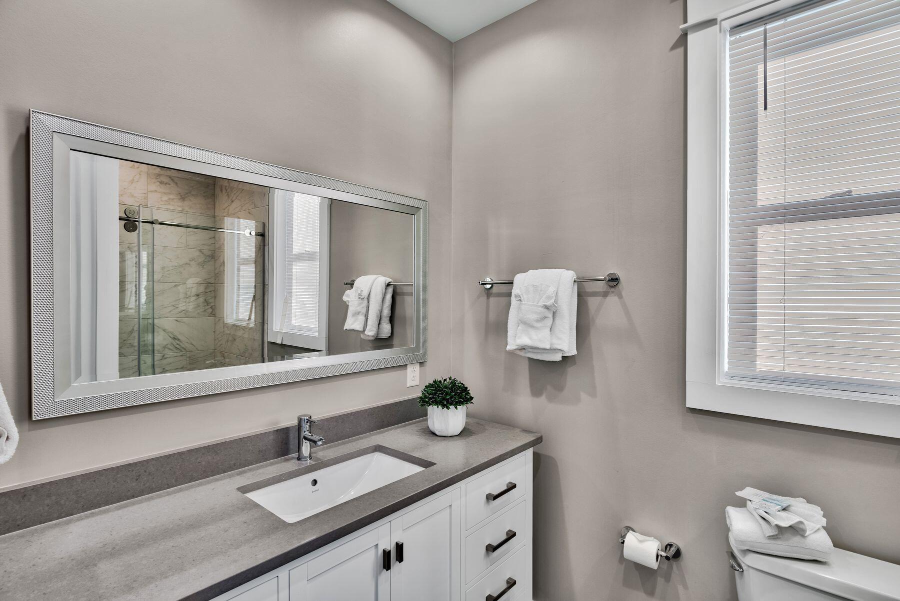 106 St Simon Circle Miramar Beach, FL 32550 - Photo 21 of 27 a bathroom with a sink vanity granite and a mirror