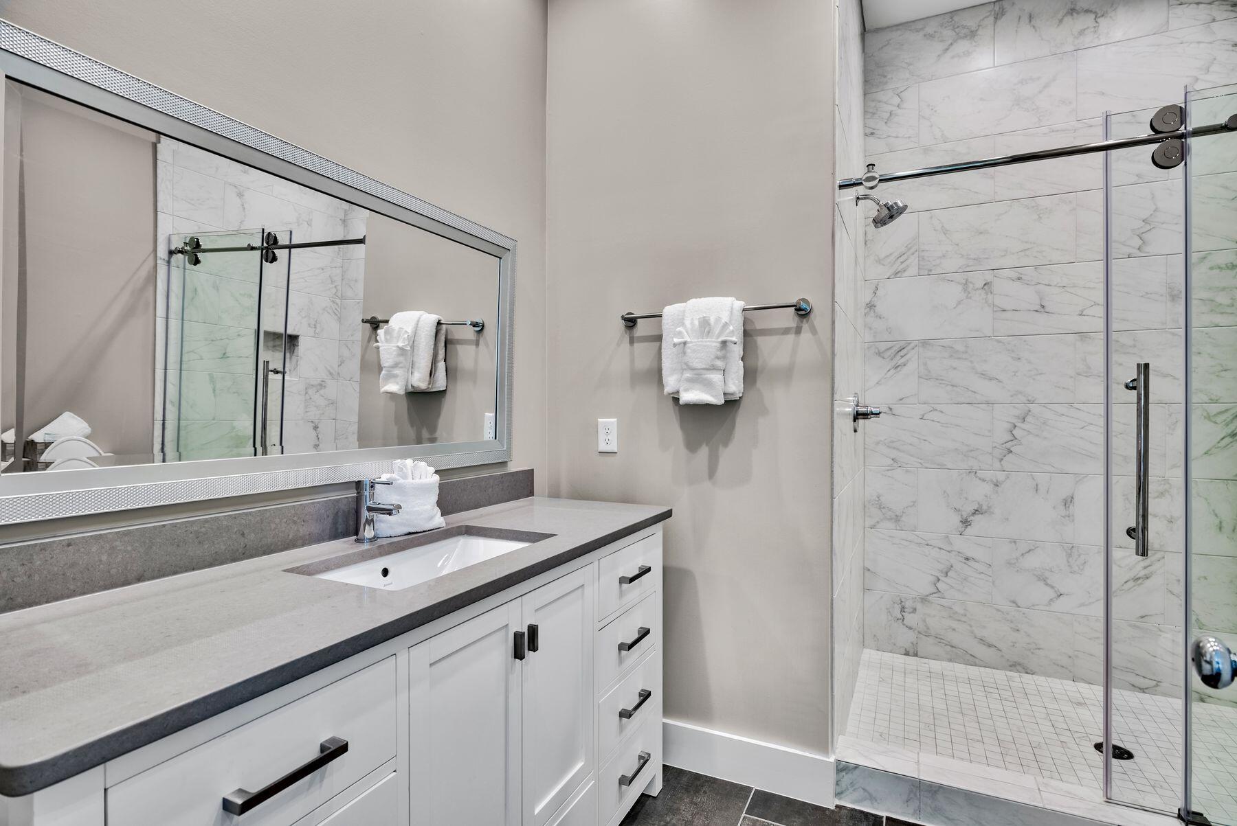 106 St Simon Circle Miramar Beach, FL 32550 - Photo 23 of 27 a bathroom with a double vanity sink mirror and shower