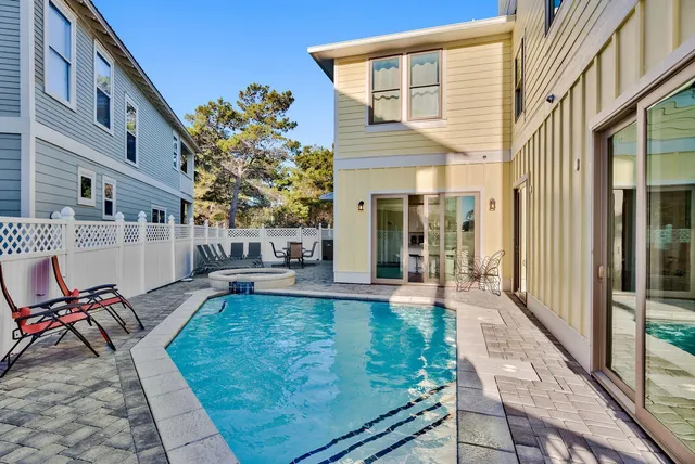 a view of a house with backyard and sitting area