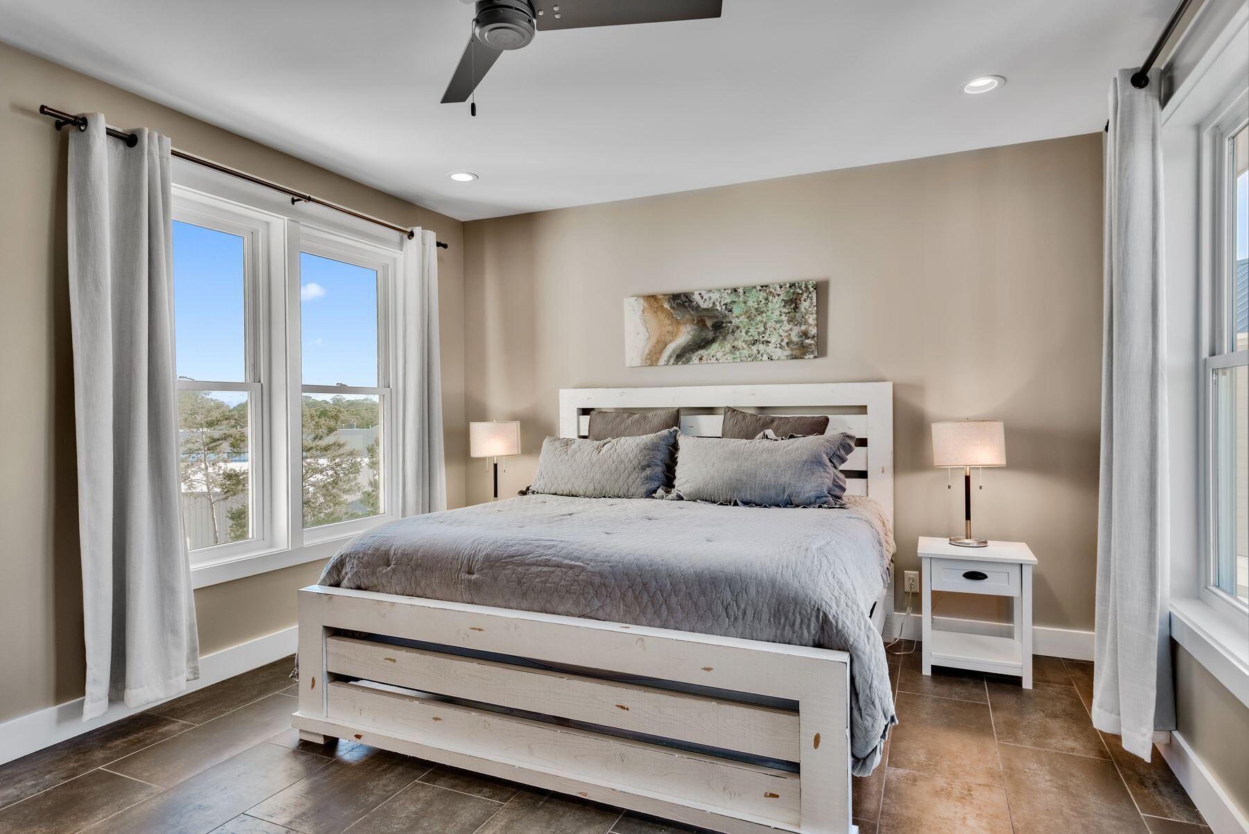 106 St Simon Circle Miramar Beach, FL 32550 - Photo 9 of 27 a bedroom with a bed and wooden floor